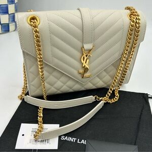 Women’s Saint Laurent YSL medium quilted leather envelope bag made in Italy.